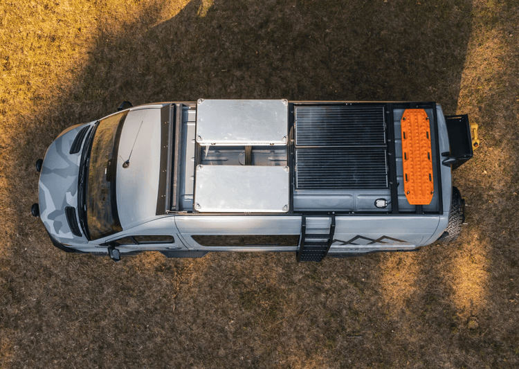 Overland rig setup with rooftop tent, recovery gear, and modular outdoor storage.