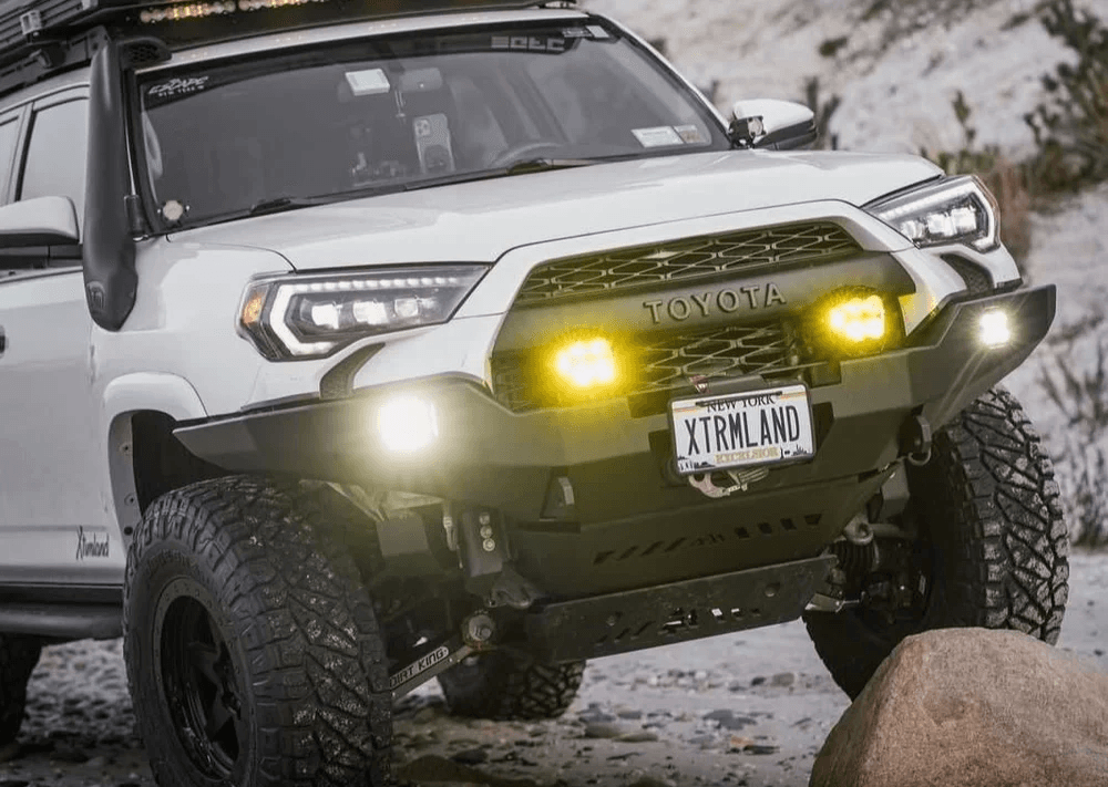 OZK technician installing upgraded suspension hardware during a custom build process.