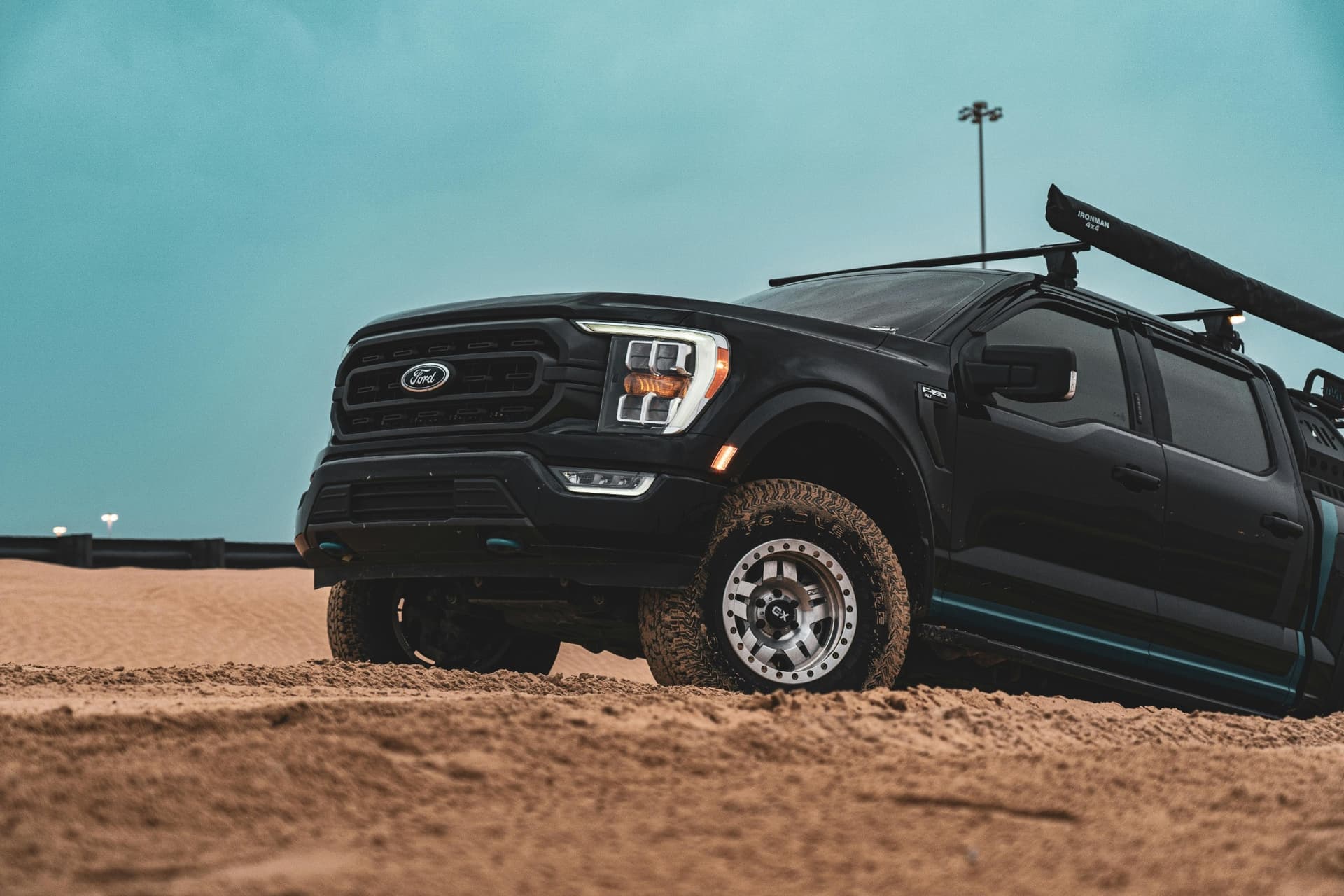 OZK-built Ford F-150 prepped with lift kit, camp gear, and off-road wheels — ready to explore the unknown.