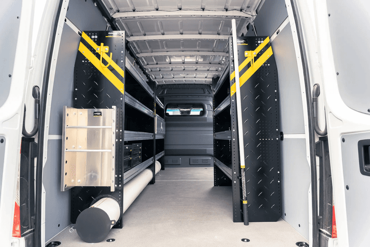 Interior layout of a custom commercial van with built-in cabinetry, storage, and modular work surfaces.