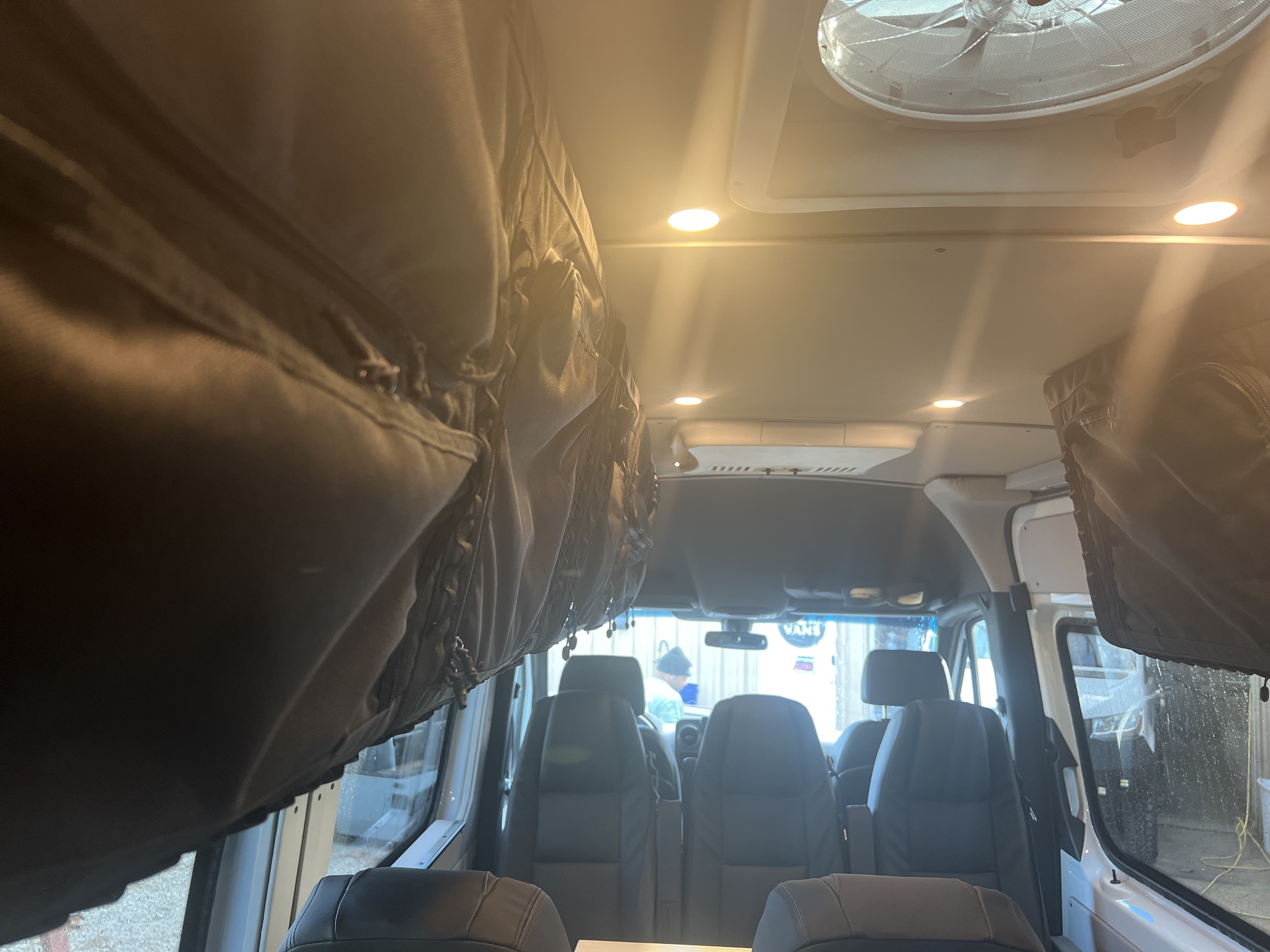 Custom cabinetry and storage solutions inside an OZK camper van.