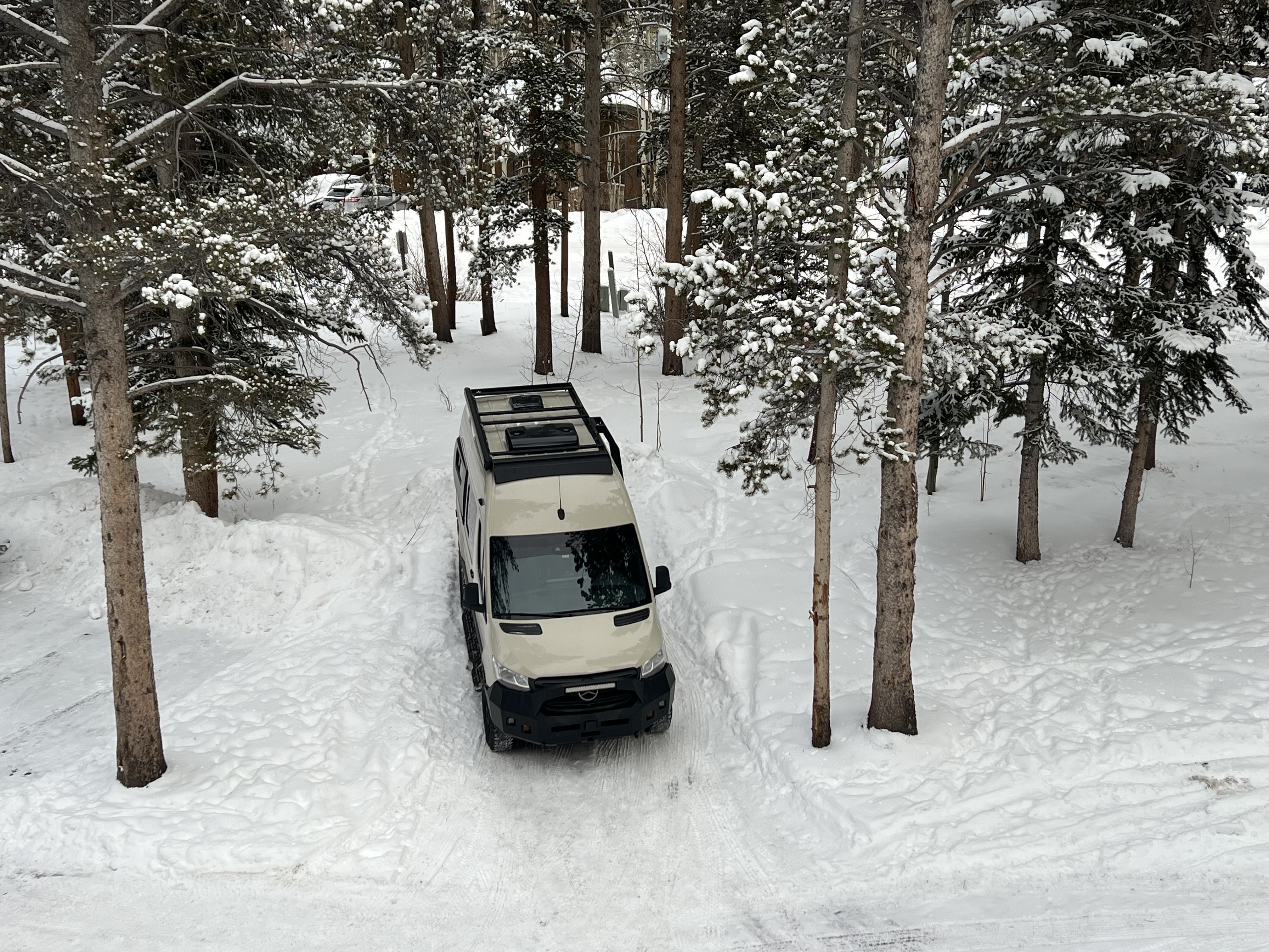 One of our Sprinter builds mid-journey — loaded with off-grid systems, roof gear, and rear garage.