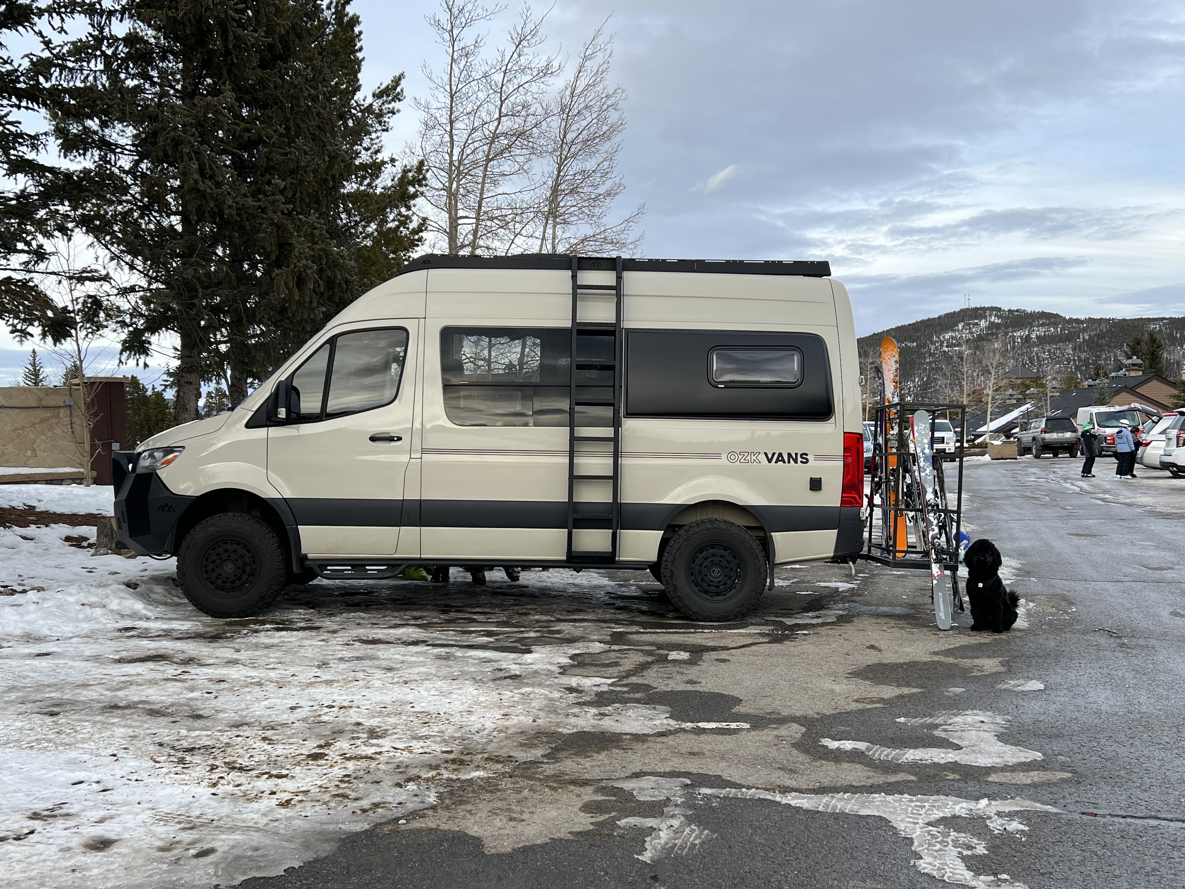 In-progress van build at OZK Customs with insulation and subfloor installed.
