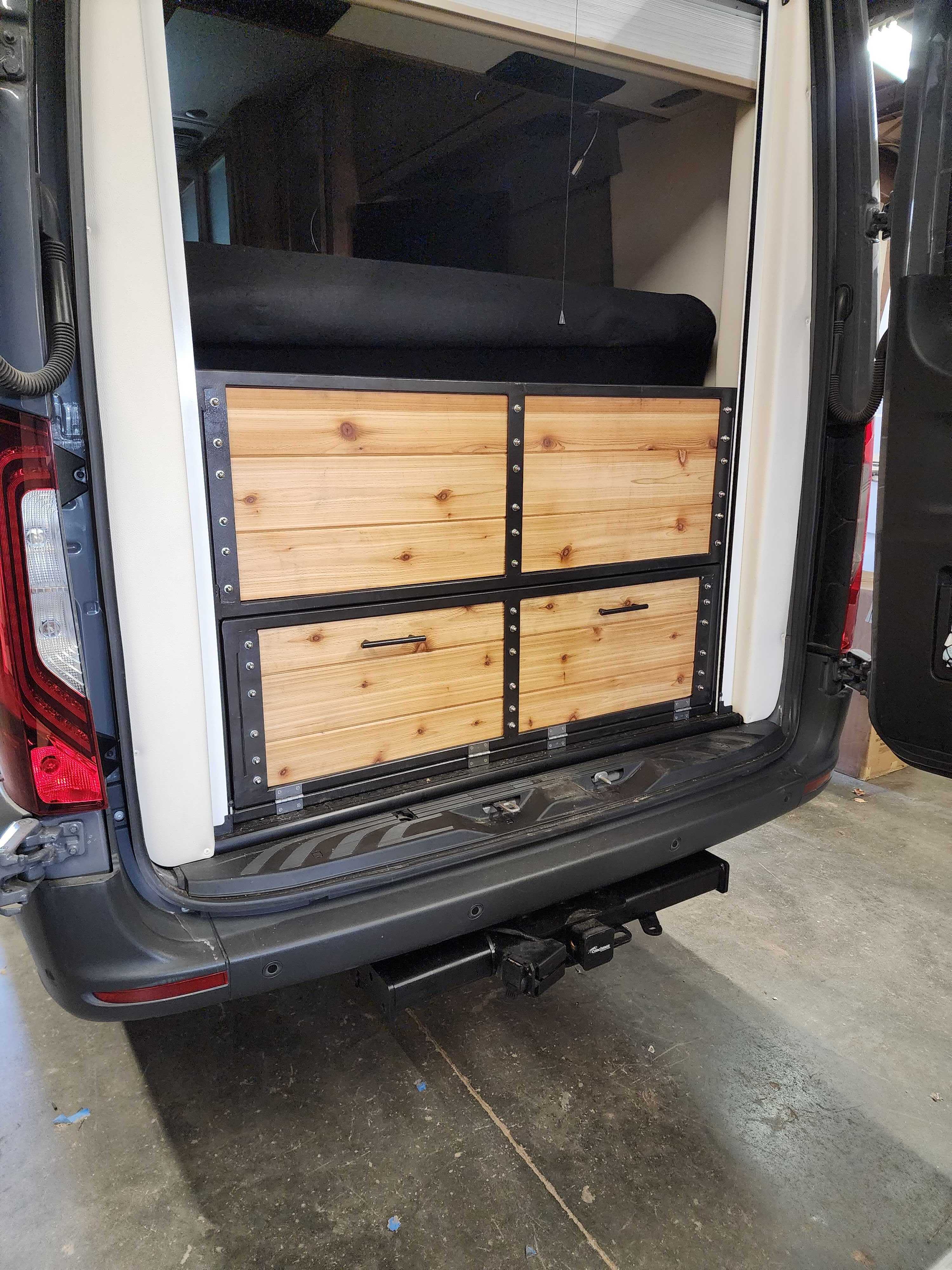 Interior shot of a van in progress at OZK Customs with exposed walls and frame layout.